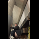 Miss Marilyn squats with her pants down under outdoor concrete stairs. No pooping shown. Presented in 720P vertical HD format. About a minute.